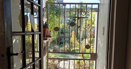This cozy home is nestled in a beautiful secret garden.
