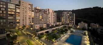 Apartment in Tilal Fanar, Terrace, great for BBQ, pools, wifi,gym,parking,security