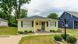 A single-story house with a front porch, a small front yard, and a mailbox.