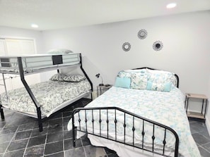 A dormitory room with two bunk beds, a desk, a chair, and a nightstand. - Entire Waterfront Property on the Hillsborough River .Sleeps up to 14 Guests!!! (Tampa)
