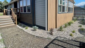 A single-story house with a wooden exterior, a covered porch, and a chimney. - Livingston MT Paradise Unit B (Livingston)