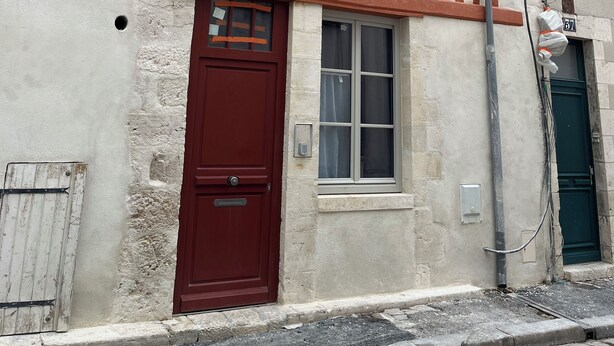 A traditional half-timbered building with a red door, a small window, and a number '37' on the wall. - Cosy furnished studio in a quiet location near the Cathedral (Orléans)