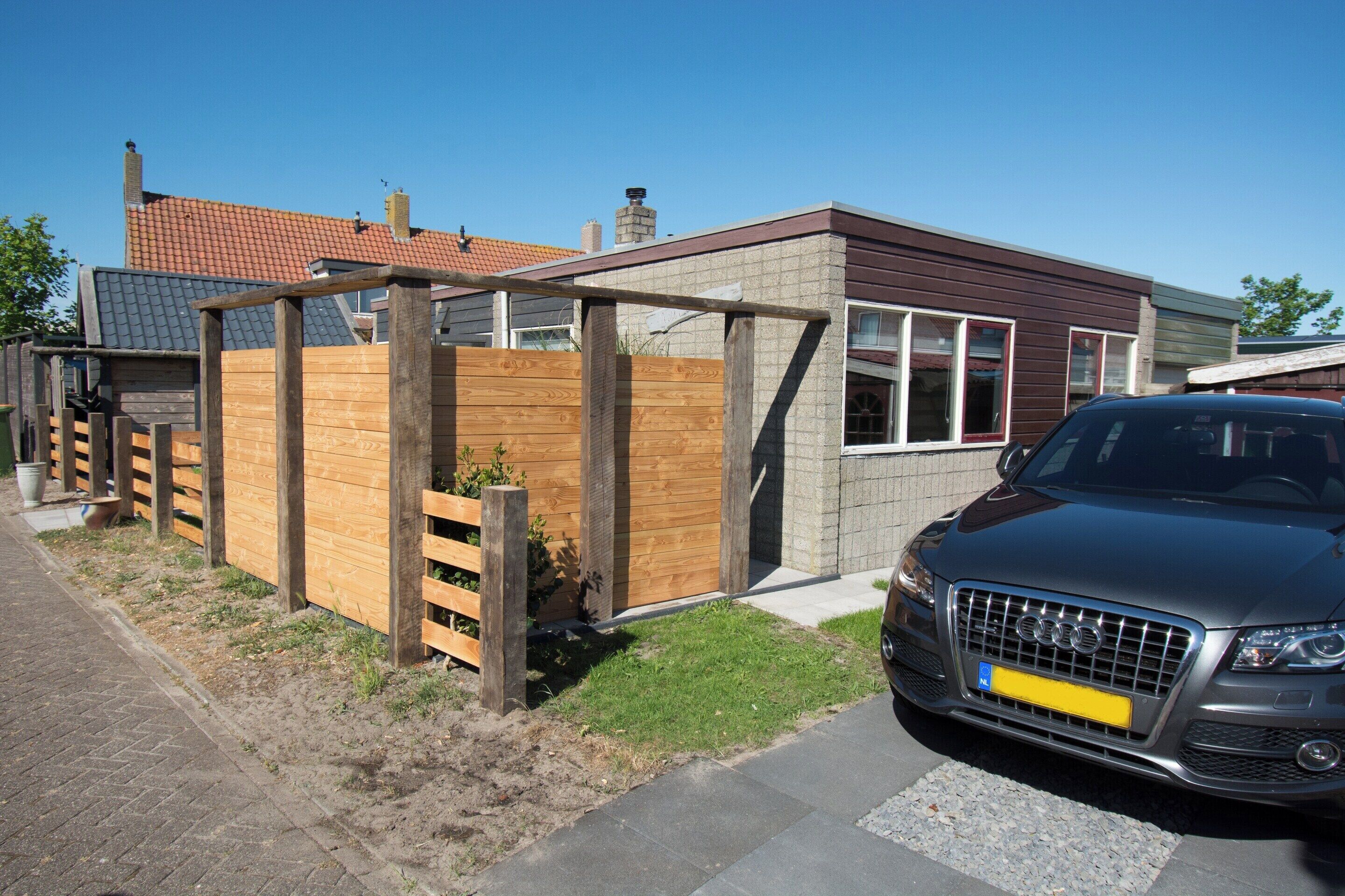 A modern house with a car parked in front.