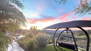 A patio with a swing chair, a small pool, and a view of a valley. - NEW LISTING…Spectacular Fallbrook Custom Estate on 2 acres with incredible views (Fallbrook)