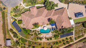 An aerial view of a residential property with a swimming pool, solar panels, and a well-maintained garden. - NEW LISTING…Spectacular Fallbrook Custom Estate on 2 acres with incredible views (Fallbrook)