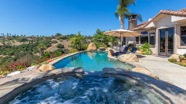 A pool with a hot tub, lounge chairs, and a view of the surrounding landscape. - NEW LISTING…Spectacular Fallbrook Custom Estate on 2 acres with incredible views (Fallbrook)