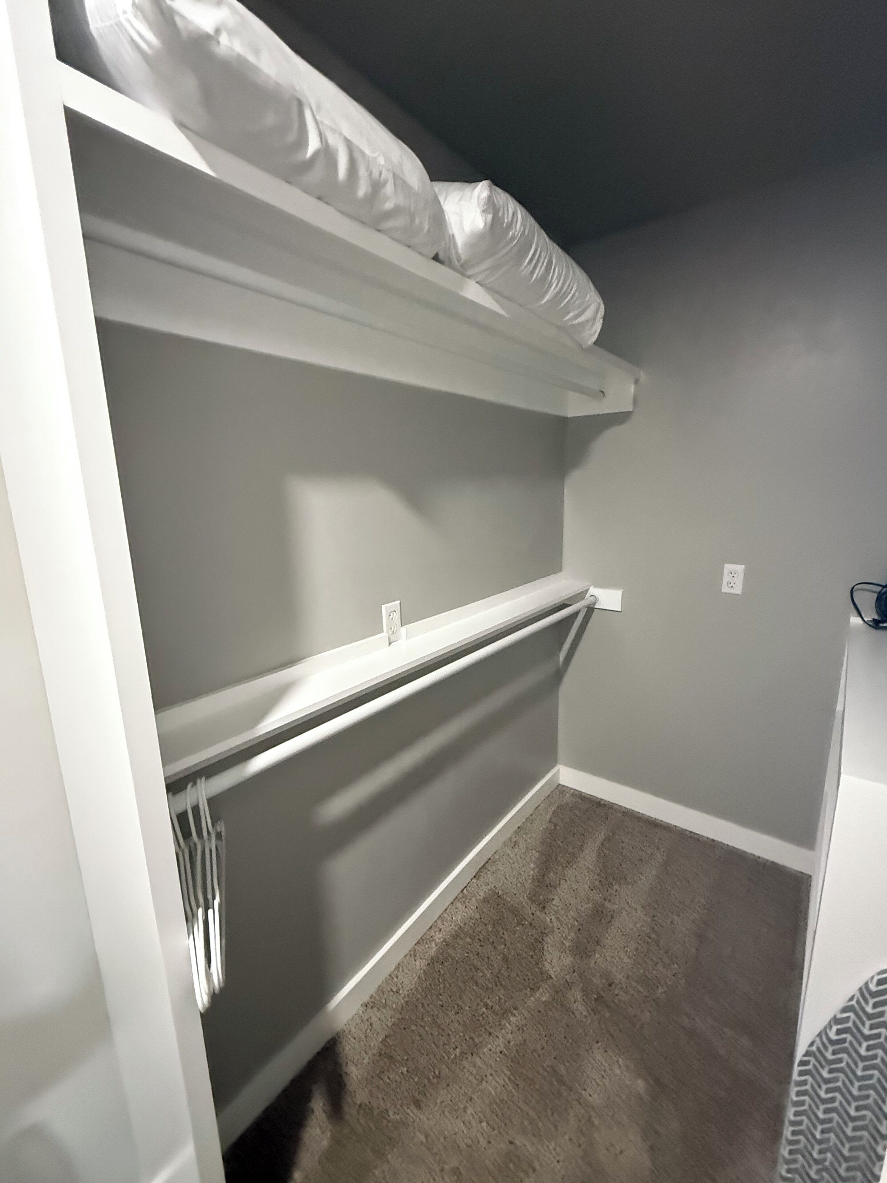 A room with a bunk bed, a radiator, and a carpeted floor.