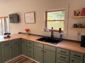 Fridge, microwave, coffee/tea maker, cookware/dishes/utensils