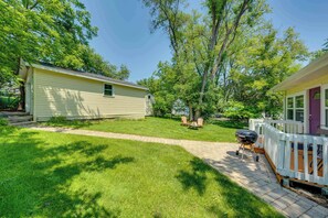 A two-story house with a covered porch and a fenced backyard. - Lakeview Lodge - Stay for 6 (Lake Geneva)