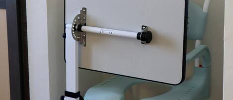 A corner of a room with a white door, a light blue baby stroller, and a white wall.