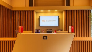 A conference room with a large screen displaying "Rest by DEDEMAN" and a podium with a microphone. - Rest by Dedeman Sapanca (Sapanca)