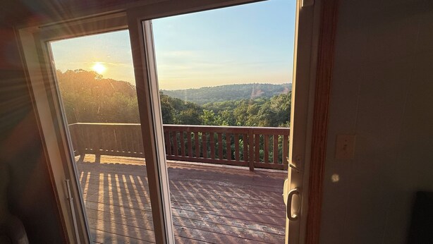 A wooden deck with a view of a forested landscape and a sunset. - A peaceful, forest retreat with stunning views near historic Harpers Ferry. (Harpers Ferry)