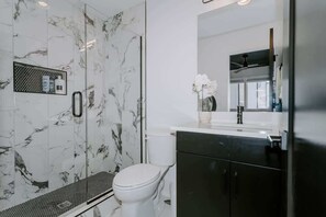 Shower, hair dryer, towels, shampoo