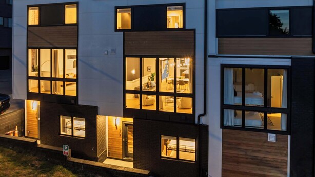 A modern multi-story residential building with large windows, a flat roof, and a garage. - Artsy Luxe Nashville Stay |Rooftop Hot Tub & Views (Nashville)