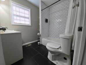 Een haardroger, handdoeken, zeep, toiletpapier