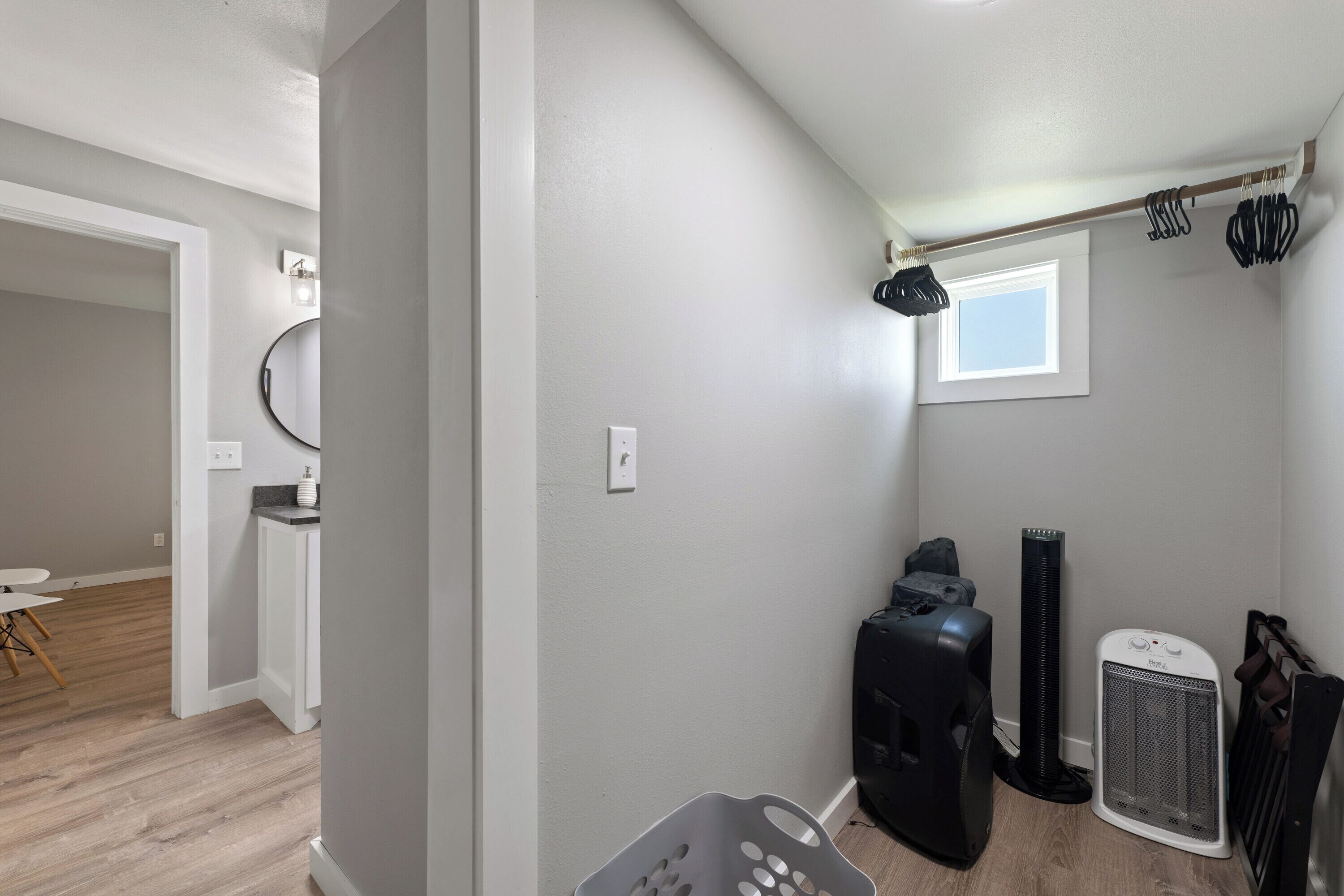 A compact living space with a kitchenette, a dining area, and a small window.