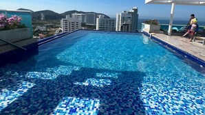 A rooftop pool with a view of the city and hills in the background. - Style and comfort by the Caribbean (Gaira)