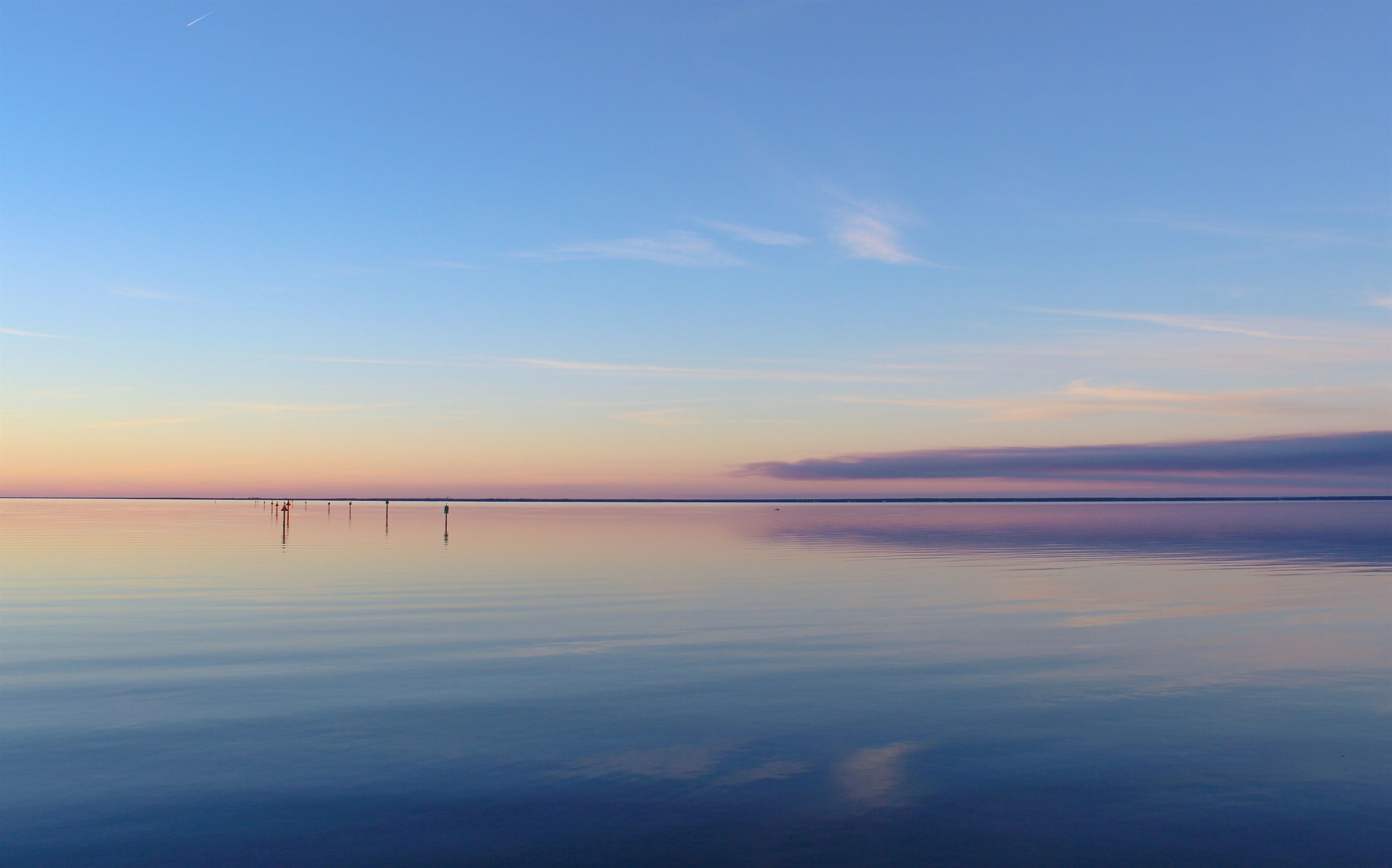 A calm body of water with a clear sky.