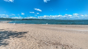 En strand med klar himmel och stilla hav.