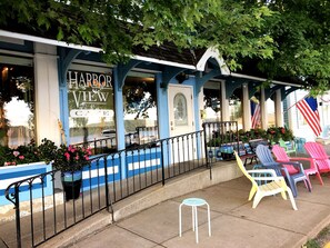 A Harbor View Cafe with outdoor seating and American flags.