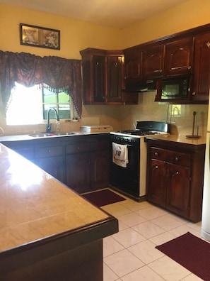 Family Apartment, Garden Area | Private kitchen | Full-sized fridge, microwave, oven, stovetop