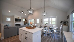 A spacious kitchen with a central island, white cabinetry, and pendant lighting. - Carova Beach, 4x4, Wild Horses, New home built in 2025.
🏝 (Corolla)