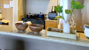 A modern kitchen with a central island, wooden cabinets, and a stainless steel refrigerator. - Ocean View Waikiki Luxury Ilikai Hotel~ (Honolulu)