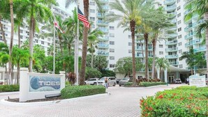 A hotel entrance with a sign reading "The Tides 3801" and "Welcome, Valet Parking Only."