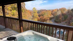 A hot tub on a wooden deck with a view of autumn trees. -  Washer dryer arcade game hot tub Waterview 3 bedroom 4 bed Awesome cabin.  (Sevierville)