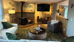A cozy living room with a stone fireplace, a television, and comfortable seating. - The Outlook-Golden Gate Canyon, Black Hawk
3BR/2BA mountain home sleeps 6 guests (Black Hawk)