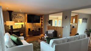 A modern living room with a fireplace, a television, and a cozy seating area. - The Outlook-Golden Gate Canyon, Black Hawk
3BR/2BA mountain home sleeps 6 guests (Black Hawk)