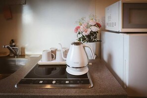 Mini-fridge, microwave, stovetop, cookware/dishes/utensils