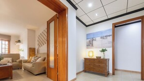 A spacious living area with a sofa set, a wooden cabinet, and a decorative wall piece. - Corbella by Interhome (Deltebre)