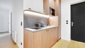 A compact kitchen with a microwave, toaster, and a small countertop.