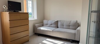 A light spacious room,with sofa and single bed. Private bathroom with shower.