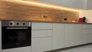A modern kitchen with a built-in oven, a stainless steel sink, and a wooden countertop. - Luxury Nest with Panoramic Wiews 10 min from Loro Park (Los Realejos)