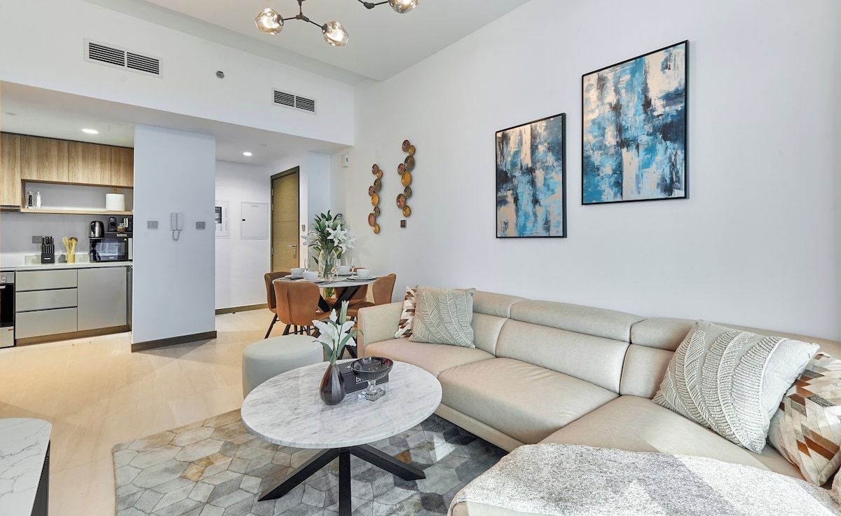 Une chambre d’hôtel moderne comprenant un espace salon, un coin repas et une cuisine.