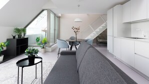 A modern apartment with a dining area, a sofa, a staircase, and a kitchen. - JULIUS 23: Cozy Stay - 5 Mins to City Center (Wien)