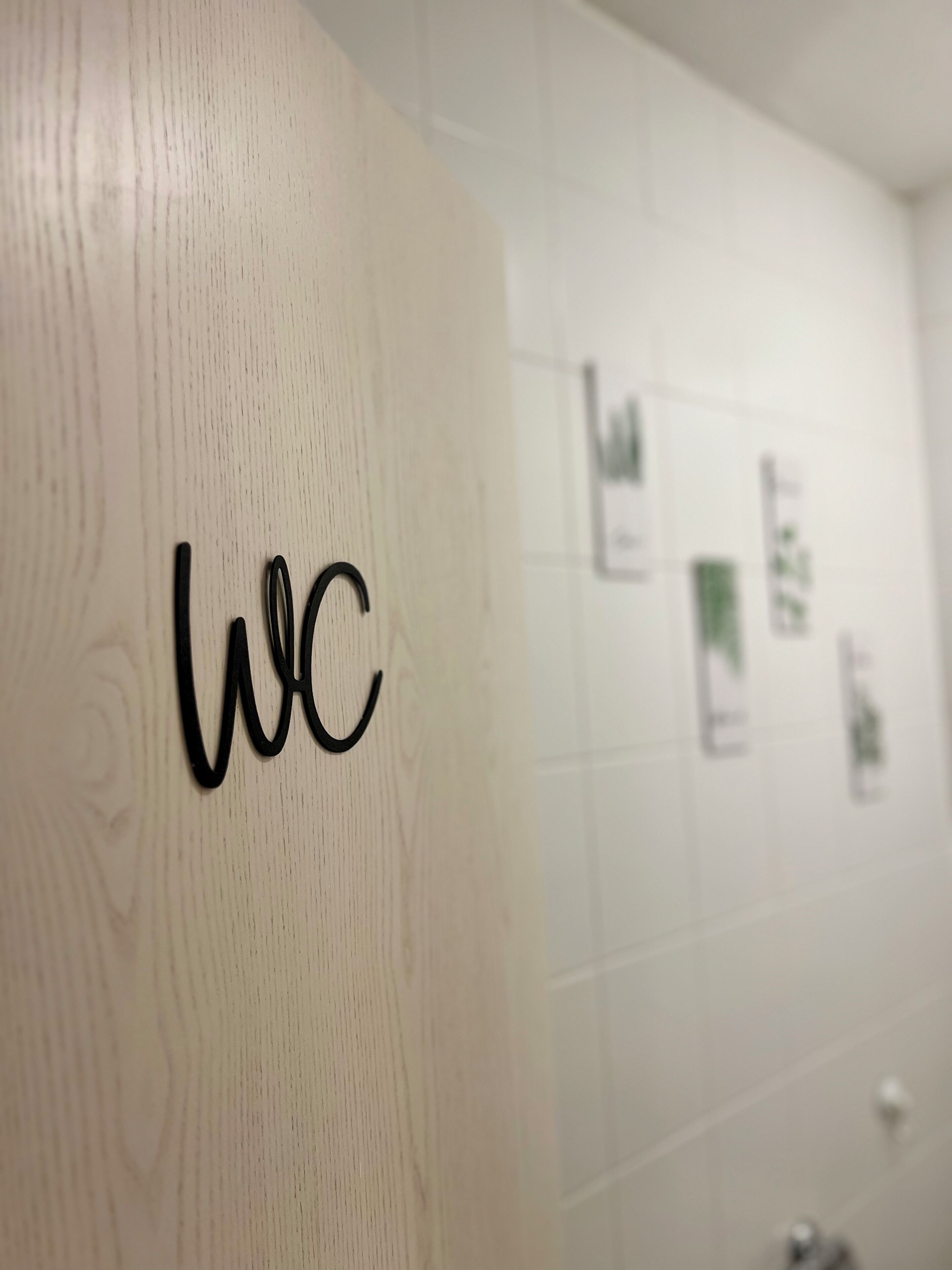 A wooden door with the letters "wc" indicating a restroom.