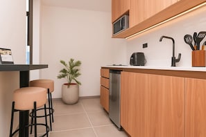 Microwave, coffee/tea maker, cookware/dishes/utensils, dining tables