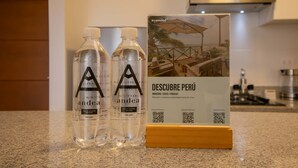 Two bottles of water and a brochure on a kitchen counter. - w Cozy Bright 2BR Stay in Barranco (Lima)
