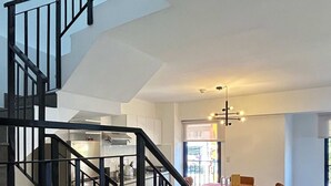 A modern interior with a staircase, dining area, and kitchen. - w Trendy 2BR Duplex Retreat in Cusco (Cusco)