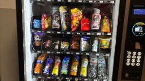 A vending machine stocked with snacks, drinks, and other items.