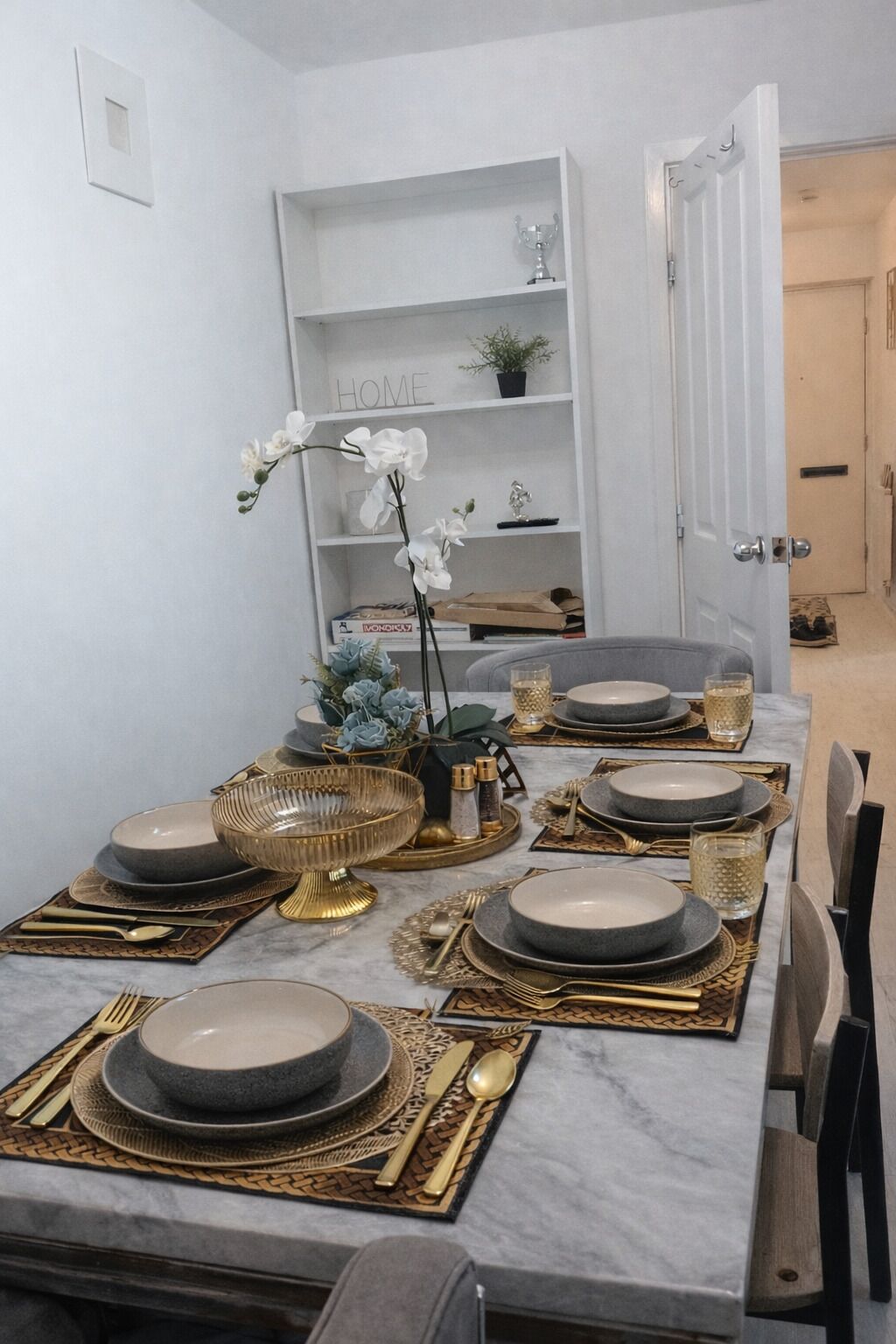 A dining table set with plates, cutlery, and decorative items.