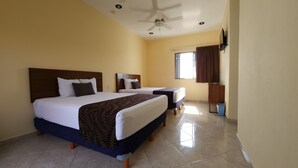 A hotel room with two beds, a ceiling fan, a window with curtains, and a trash bin. - Hotel San Miguel Playa del Carmen (Playa del Carmen)