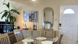 A dining area with a wooden table, chairs, and a ceiling fan. - Unique Home on Peaceful Waterfront (Stafford Township)