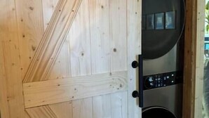 A wooden door with a circular window and a control panel. - Unique Home on Peaceful Waterfront (Stafford Township)