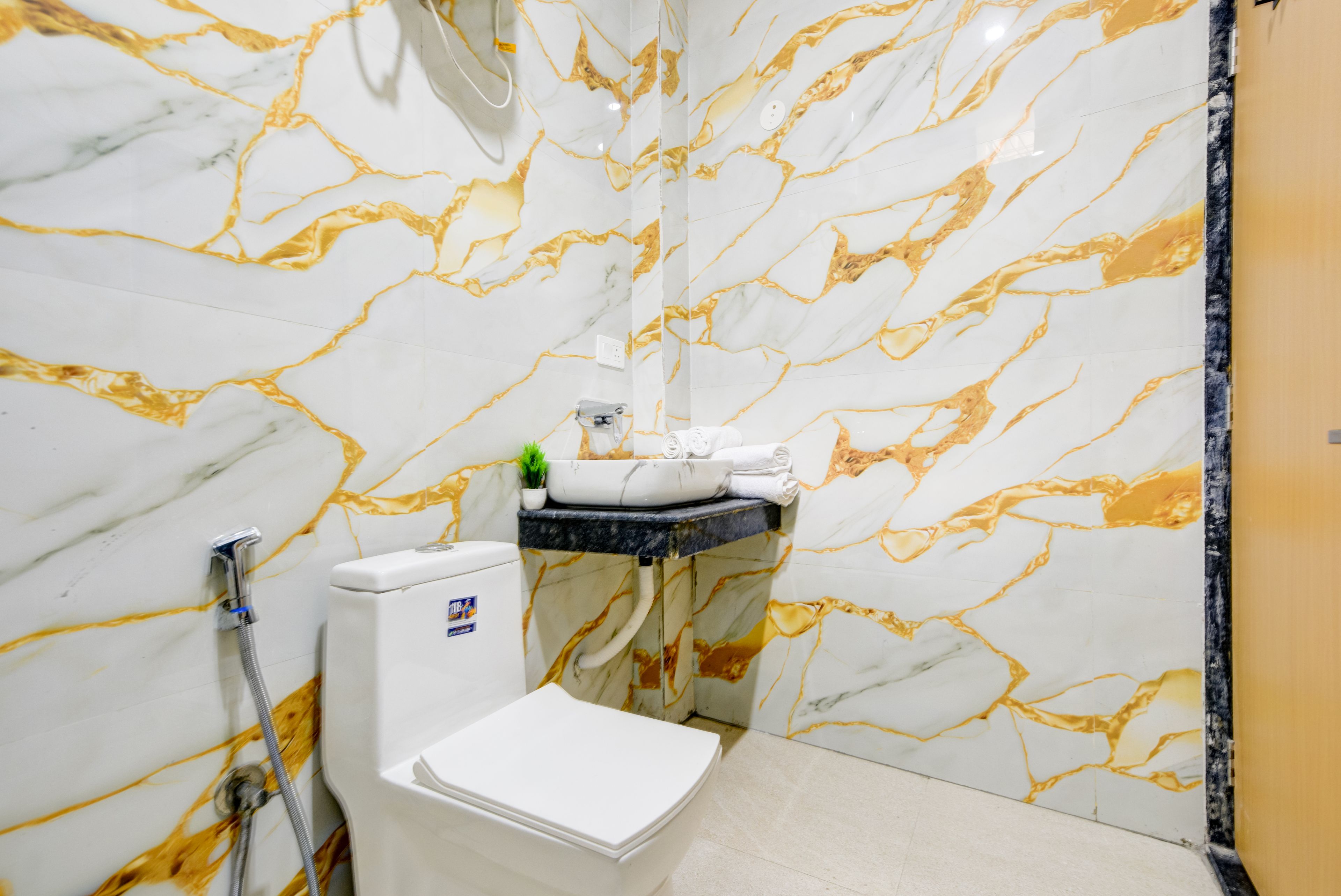 A bathroom with a toilet, a sink, and a shower.