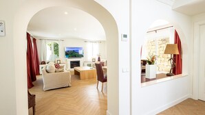 A spacious living room with a fireplace, a television, and a view of a scenic landscape. - Luxury villa in the center of Marbella (Marbella)