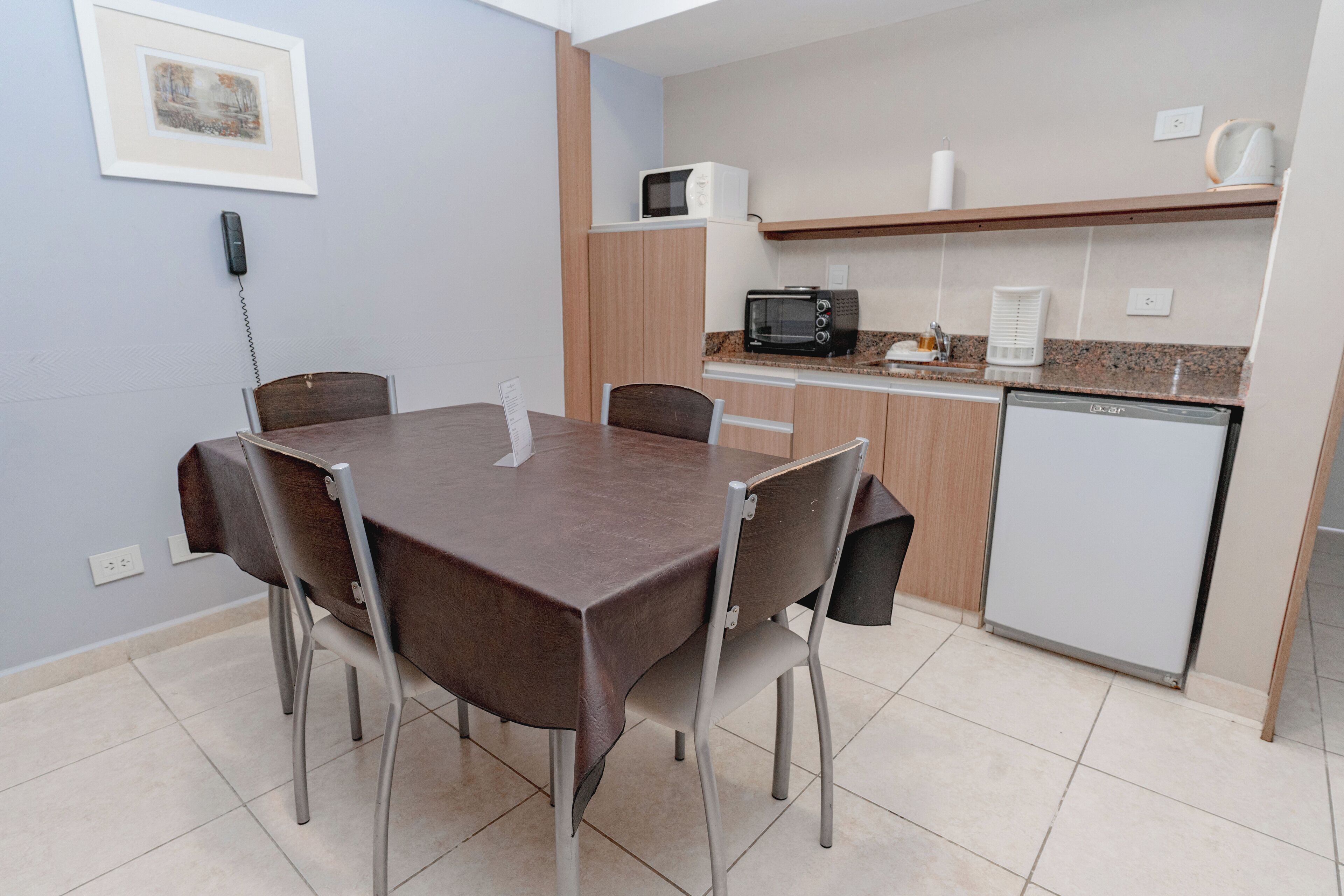 A compact kitchen with a microwave, toaster, and refrigerator.